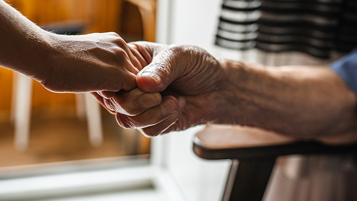 Volunteer hand in hand with patient