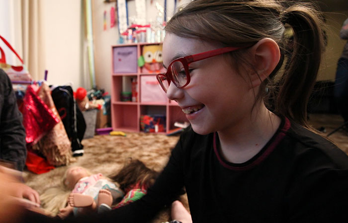 Aviana playing with dolls in a room