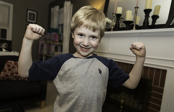 Cael flexing his bicep muscles