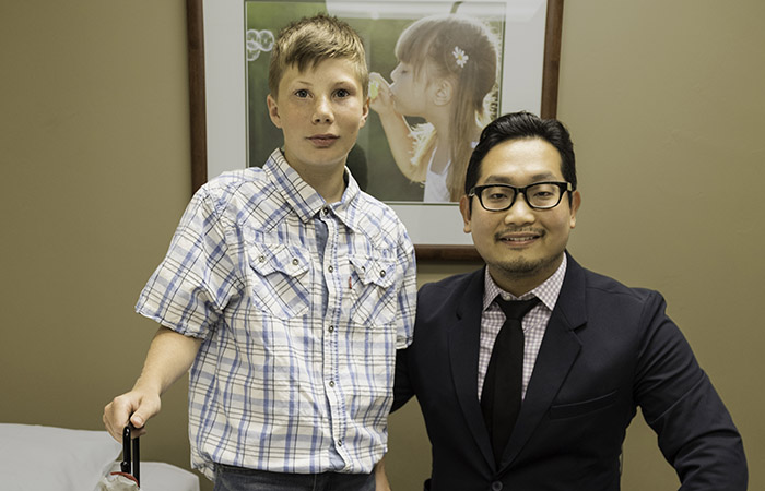 Payton standing next to Dr. Hoon Choi in a patient room