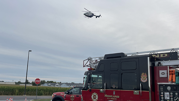 Helicopter coming in for landing near emergency vehicles