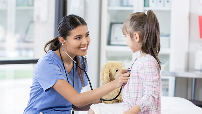 Female nurse talking with a young pediatric patient