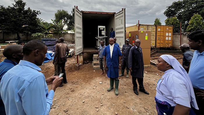 Matthew (in the blue jacket) stands in the center of the action.