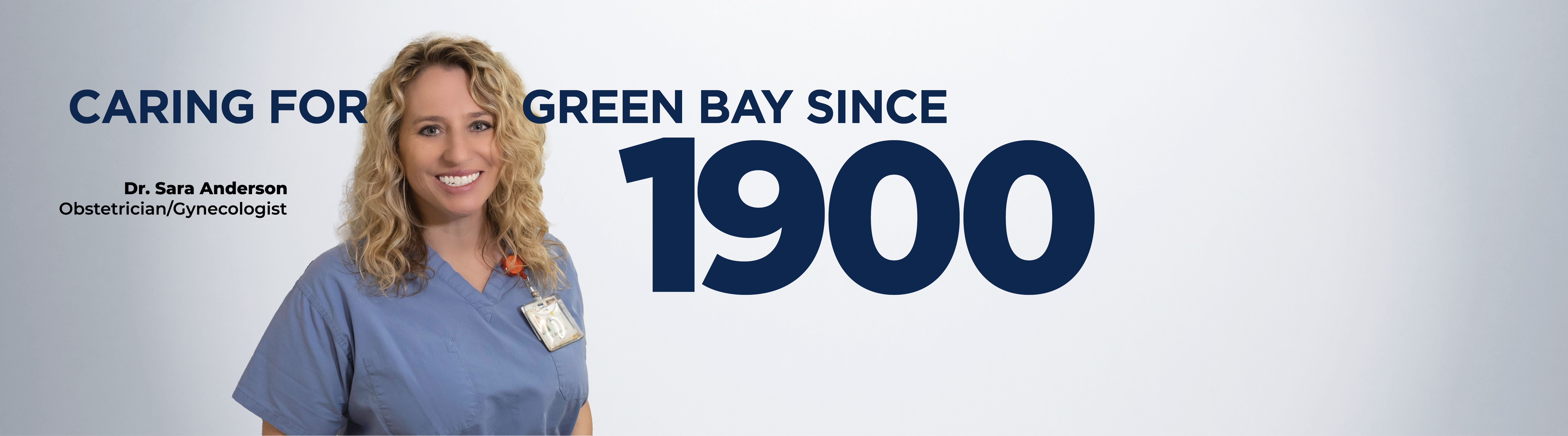 Dr. Sara Anderson stands facing camera smiling with text on screen that reads "caring for Green bay since 1900"