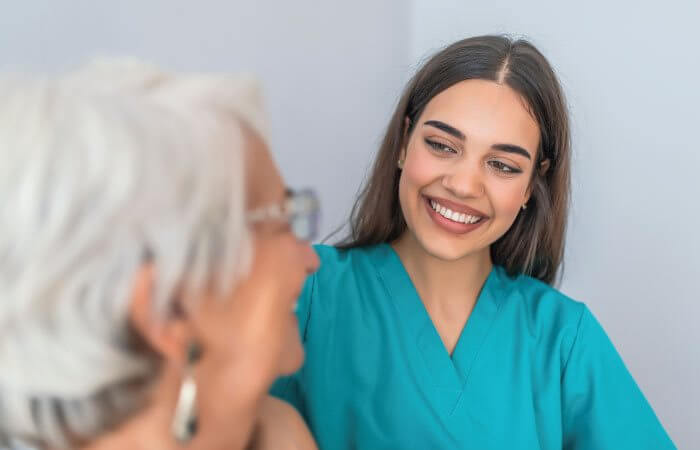 female nurse speaks to elderly patient 